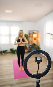 Yoga practice in a cozy studio with soft lighting and plants Stock Photos