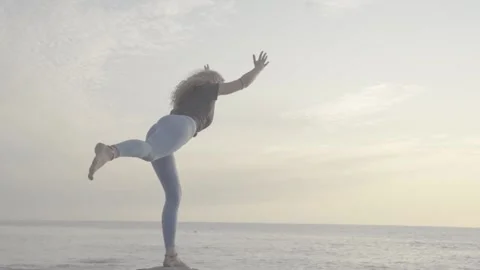 A yoga practice by the ocean Stock Footage 145871370
