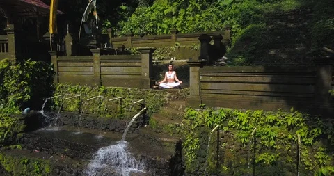 Yoga practicing at waterfall Stock Footage 92966750