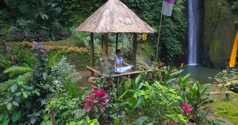 Yoga practicing at waterfall Stock Footage 92978891