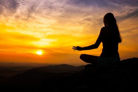 Yoga practicioner in sunset Stock Photos