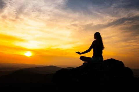 Yoga practicioner in sunset Stock Photos