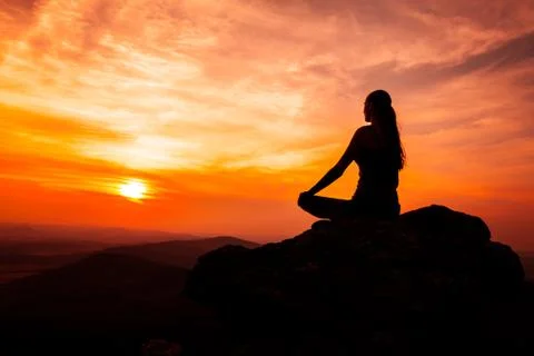 Yoga practicioner in sunset Stock Photos