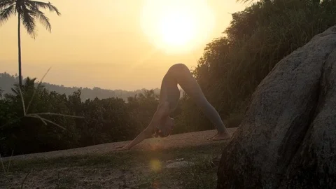 Yoga practitioner changes sun salutation poses slow motion Video stock 112258841