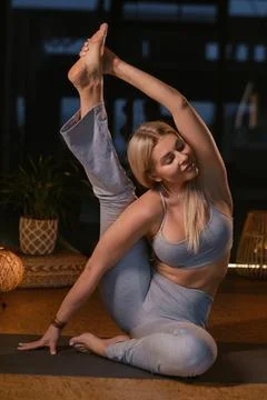 Yoga practitioner demonstrates impressive flexibility in serene studio sett.. Stock Photos