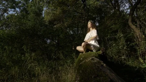 Yoga practitioner doing breathing exercise in the woods nature Stock Footage 83143309