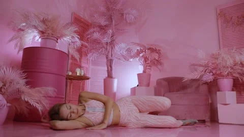 Yoga practitioner doing exercises in a pink room where peace reigns Stock Footage 149902250