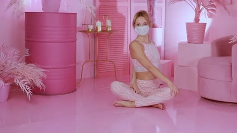 Yoga practitioner doing exercises in a pink room where peace reigns Stock Footage 149902279