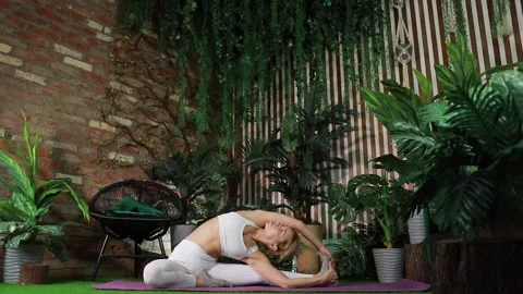 Yoga practitioner doing exercises in a room where peace reigns Stock Footage 149902222
