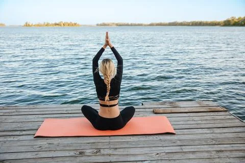 Yoga by the river. Stock Photos