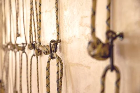 Yoga ropes hanging on empty studio wall. Iyengar yoga Stock Photos