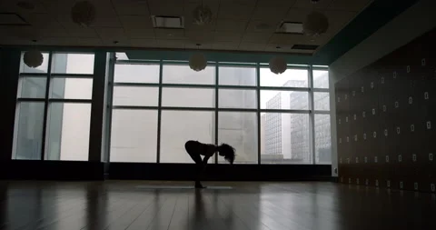 Yoga student stretching in empty studio 動画素材 138040989