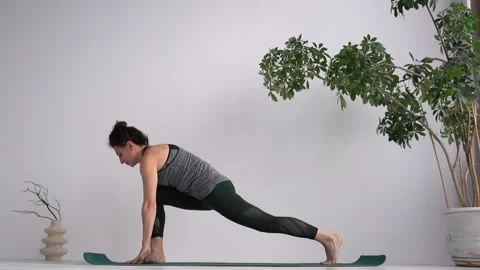 Yoga studio and instructor conducts a lesson. Attractive curly-haired girl Stock Footage 153286956