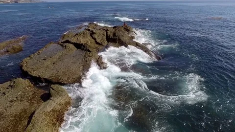 Yoga teacher doing yoga on the cliffs in the sea. Aerial drone view. Stock Footage 73684961