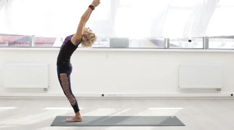 Yoga trainer doing exercise at the gym Stock Footage 66474696