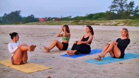 Yoga trainer teaches how to do asana Stock Footage 265840713