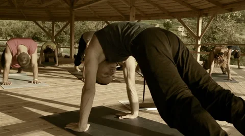 Yoga training: instructor and his followers holding a stance Video stock 53677389