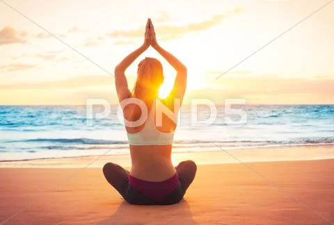 Yoga woman at sunset Stock Photos
