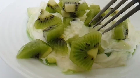 Yoghurt with kiwi fork Stock Footage 87954073