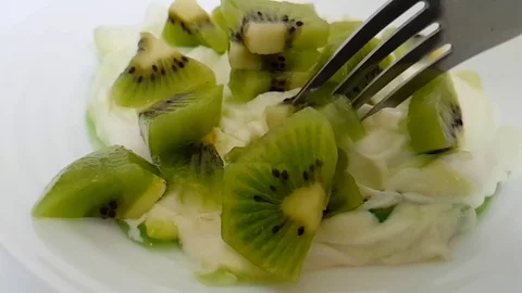 Yoghurt kiwi spoon slow motion Stock Footage 89765291