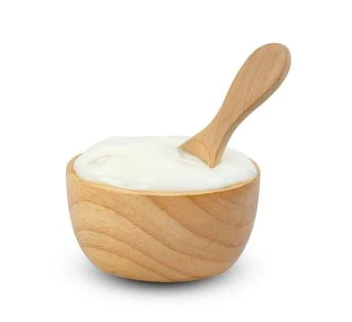 Yoghurt with nata de coco dutche in wooden bowl and spoon isolated on white.. Stock Photos