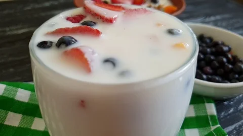 Yoghurt raspberry strawberry blueberry drops slow-motion Stock-Footage 91107445
