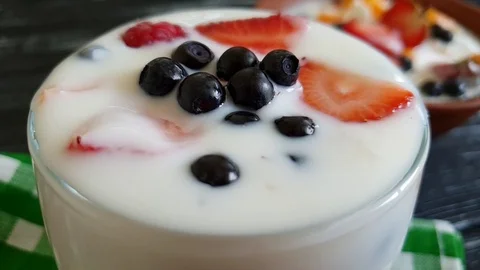 Yoghurt raspberry strawberry blueberry spoon slow-motion shot Stock Footage 91107428