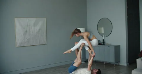Yogi couple practice. Couple young sporty peoplepracticing acrobatic yoga lesson Stock Footage 147967936