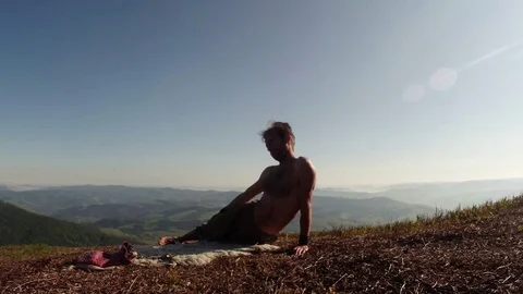 Yogi does exercises in the mountains with small errors Stock Footage 77784922
