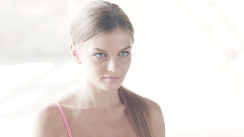 The Yogi girl is doing exercises in the middle of a large bright room. Stock Footage 80614682