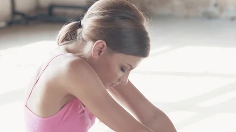 The Yogi girl is doing exercises in the middle of a large bright room. Stock Footage 80615254