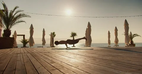 The yogi guy keeps his body on weight, remaining on two hands. Yoga practice and 動画素材 249844269