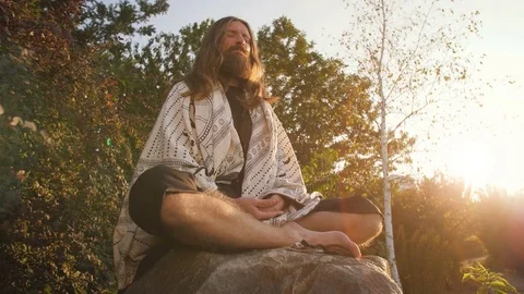 Yogi sitting in meditation Stock Footage