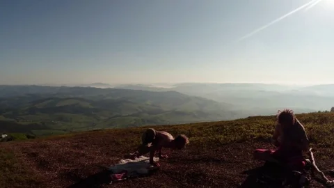 Yogi Tries to Make a Difficult Asana in The mountains under the sun, another per Stock Footage 77781706