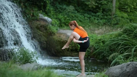 Yogic meditation practice Yogic doing yoga in water against the waterfall Stock Footage 160418296