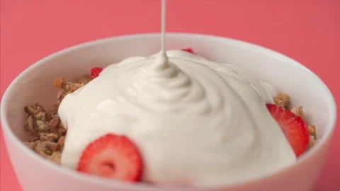 Yogurt is added to muesli Stock Footage 138982305