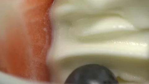 Yogurt closeup with a slice of strawberry Stock Footage 104350705