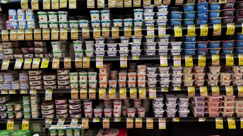 Yogurt containers on retail display shelf. Stock Footage 145283842