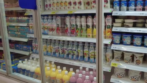 Yogurt drinks in a chiller at Tesco hypermarket. Slow motion. Stock Footage 326288046