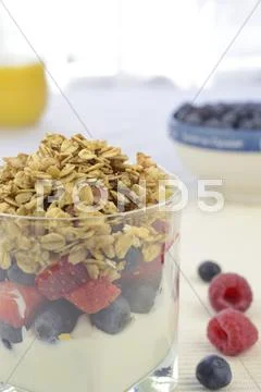 Yogurt with fresh berries and muesli (vertical) Stock Photos