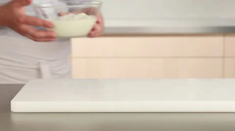 A yogurt marinade being made: ginger being grated into yogurt Stock Footage 24656970