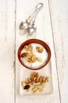Yogurt with a nut mix Stock Photos