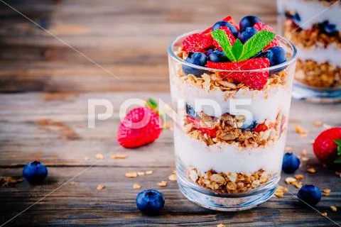 Yogurt parfait with granola, strawberries and blueberries Stock Photos