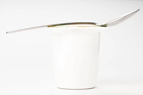 Yogurt in plastic box container over white background Stock Photos