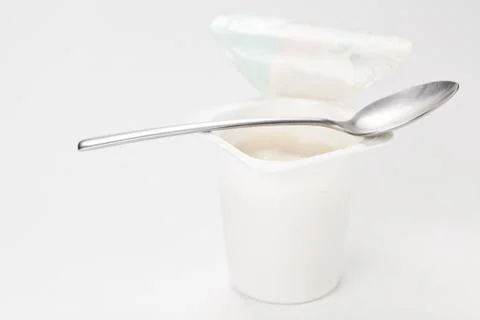 Yogurt in plastic box container over white background Stock Photos
