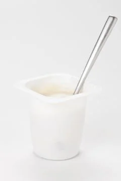 Yogurt in plastic box container over white background Stock Photos