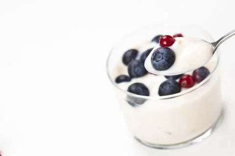 Yogurt in plastic box container over white background Stock Photos