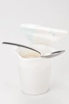 Yogurt in plastic box container over white background Stock Photos