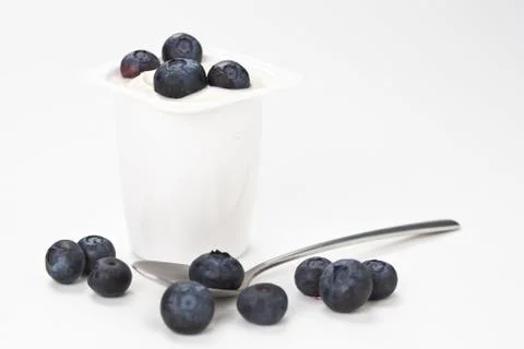 Yogurt in plastic box container over white background Stock Photos