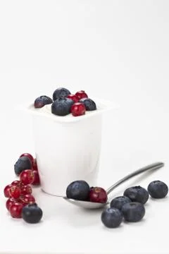 Yogurt in plastic box container over white background Stock Photos